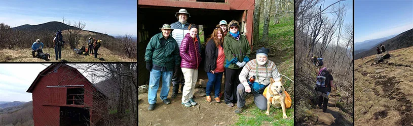 Group of hikers posing by a rustic red barn on a mountain trail, with scenic views and a dog.