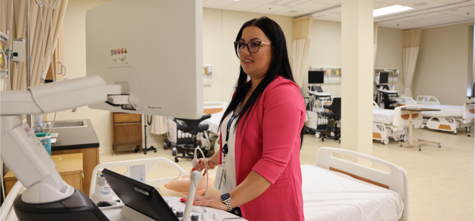 Sonography instructor, Kayla Chandler, demonstrating how to use the equipment.