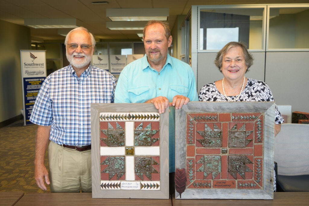 Mr. Lynn Keene of Russell County, VA (left) and Mrs. Cathy Payne of Bluefield, VA (right) with Mr. Johnny Hagerman, brick sculptor (center), presenting specially carved, handmade, and numbered brick carvings.