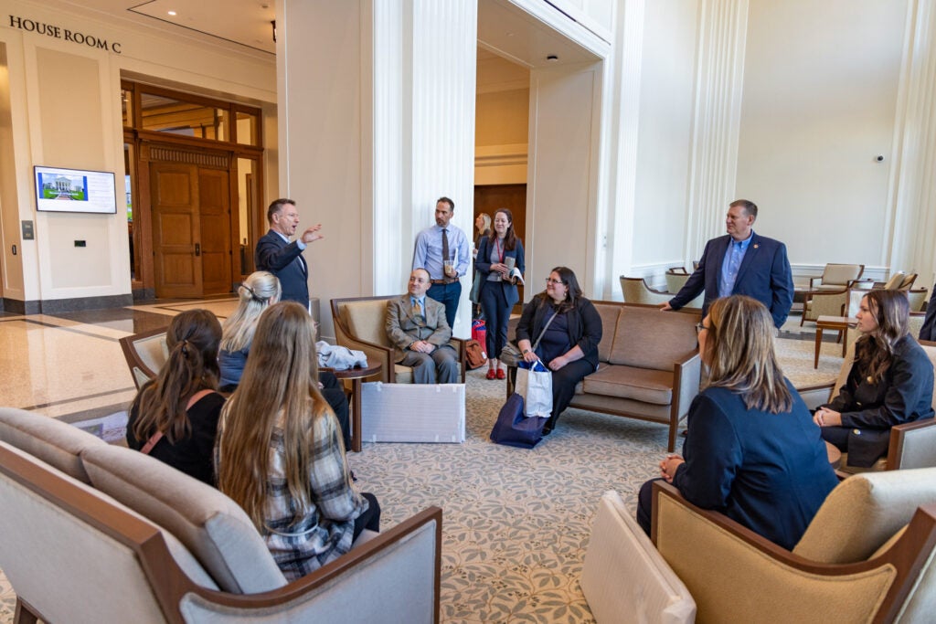 Dr. David Doré speaks with students inside the Capitol.