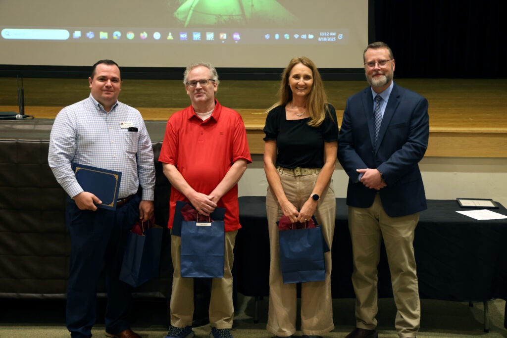 group of faculty and staff with Dr. Hayes being recognized for 10 years of service