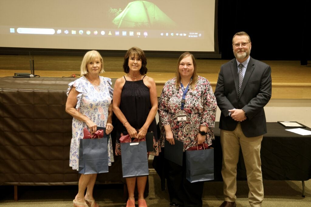 group of faculty and staff with Dr. Hayes being recognized for 15 years of service