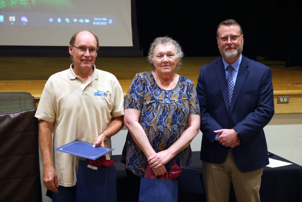 Group of faculty and staff with Dr. Hayes being recognized for 20 years of service