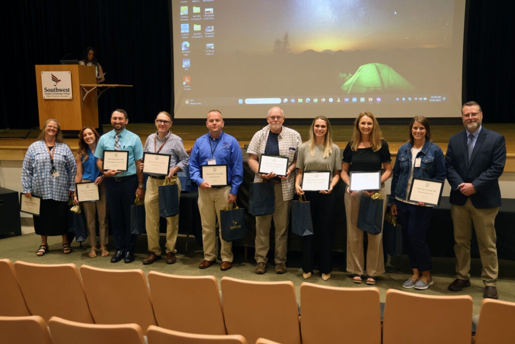 a group of Southwest Faculty and Staff being recognized for their hard work with Dr. Hayes.
