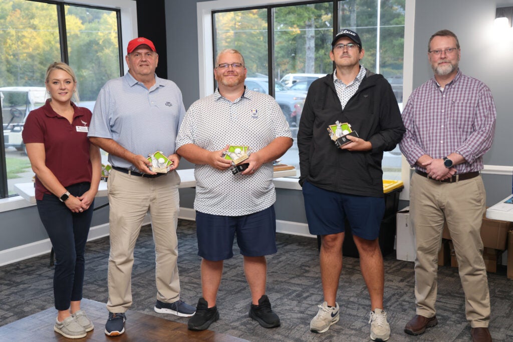 The winners and runner ups of the golf tournament with members of Southwest Staff