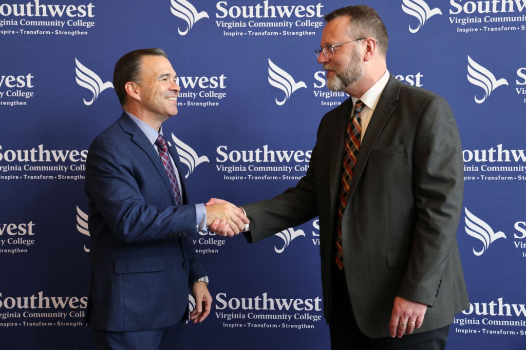 President Hayes on the right shaking hands with President Peter Stevenson