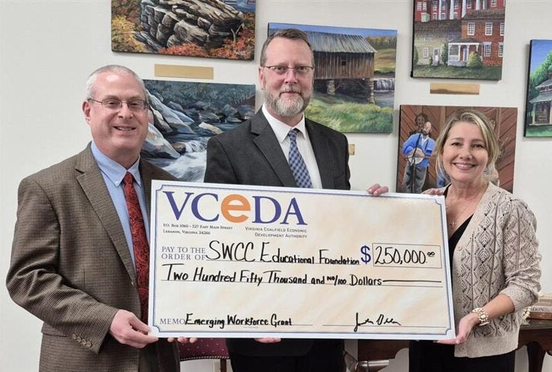 VCEDA Executive Director/General Counsel Jonathan Belcher, left, presents a ceremonial check for $250,000 to SWCC President Dr. Clint Hayes, center, and SWCC Vice President of Institutional Advancement Susan Lowe, right. The funds will assist with workforce development and training for VCEDA region students attending the college.