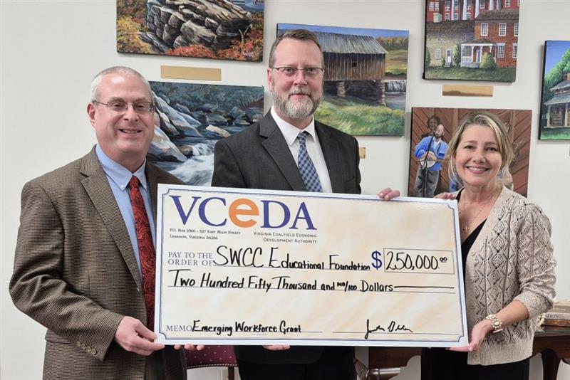 VCEDA Executive Director/General Counsel Jonathan Belcher, left, presents a ceremonial check for $250,000 to SWCC President Dr. Clint Hayes, center, and SWCC Vice President of Institutional Advancement Susan Lowe, right. The funds will assist with workforce development and training for VCEDA region students attending the college.