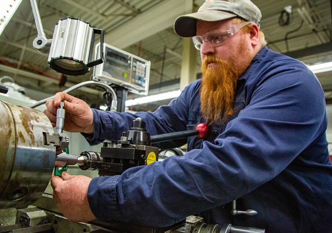 Man working in precision machine shop on-campus